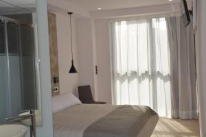 Łóżko lub łóżka w pokoju w obiekcie Hotel Bilbao Plaza