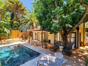 a house with a swimming pool and a tree at Botany House Boutique Retreat in Cape Town