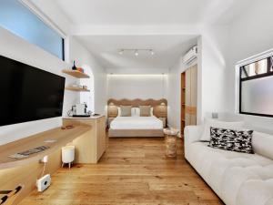 a living room with a white couch and a bed at Botany House Boutique Retreat in Cape Town