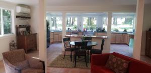 a kitchen and living room with a table and chairs at Forest Haven, Fantastic Nature Retreat! in Azalea