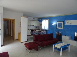 a living room with a red couch and a table at La Martlona in Riccione +2 photos