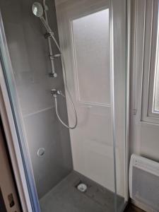 a shower with a glass door in a bathroom at Mobile home Bora bora in Vias