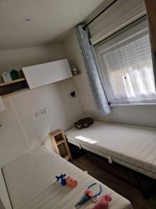a small room with two beds and a window at Mobile home Bora bora in Vias