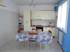 a kitchen with a table and chairs in a room at La Martlona in Riccione