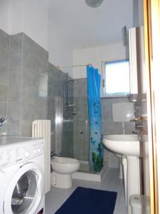 a bathroom with a washing machine and a sink at La Martlona in Riccione