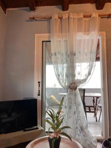 a curtain in front of a door with a window at Azure Loft in Rodhiá