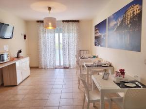 a kitchen and dining room with tables and chairs at B&B Waltanna Airport in Bari