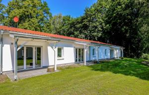 a small white building with a large yard at Nostalgie in Gransee +17 photos