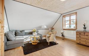 a living room with a couch and a table at 2 Bedroom Amazing Home In Grindsted in Grindsted +17 photos