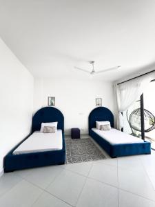 a bedroom with two beds and a window at Marina Beachfront at JUMEIRAH PALM RESORT-NYALI in Mombasa +22 photos