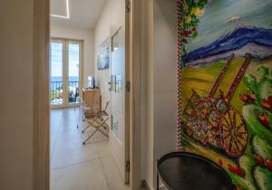 a hallway with a large painting on the wall at Zen Orlando House Appartamento con vista mare in Taormina