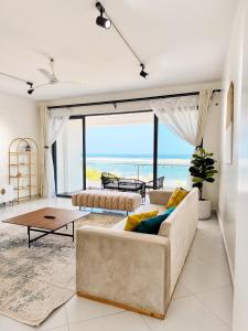 a living room with a couch and a table at Marina Beachfront at JUMEIRAH PALM RESORT-NYALI in Mombasa