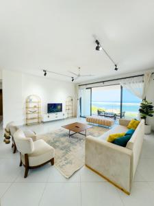 a living room with a couch and a table at Marina Beachfront at JUMEIRAH PALM RESORT-NYALI in Mombasa