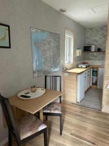 a kitchen with a wooden table and a table and chairs at Maison Vaniméou in Pouzauges