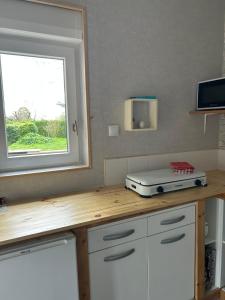 a kitchen with a counter with a toaster on it at Maison Vaniméou in Pouzauges +5 photos