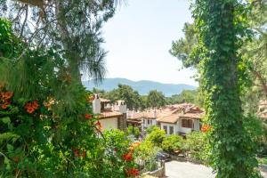 a view of a village through the trees at Esen Apartments in Ula