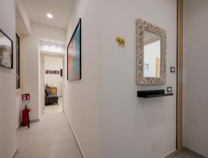 a hallway with a mirror on a wall at Zen Orlando House Appartamento con vista mare in Taormina +10 photos