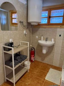 a bathroom with a sink and a toilet and a mirror at Chata U Juraja in Hruštín +23 photos