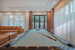 a pool table in a living room with a couch at Villa Da Nang Hoang Sa in Da Nang