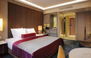 a hotel room with a large bed and a large mirror at Tangla Hotel Brussels in Brussels