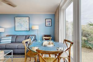 a living room with a table and a couch at Shipwatch 2373 in Kiawah Island