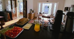 a table with a bowl of fruit and a tray of juice at Garibaldi Hostel & Pub in Curitiba +14 photos