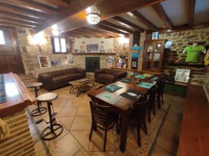 a large living room with a table and chairs at El Hogar del Ciclista in Espinosa de los Monteros