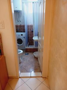 a bathroom with a toilet and a sink at B4 in Budva +6 photos
