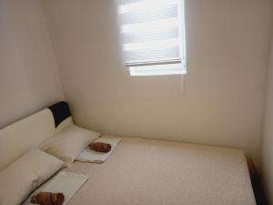 a small room with a bed and a window at B4 in Budva