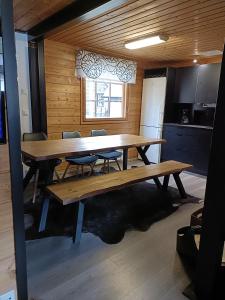 a dining room with a wooden table and chairs at Villa Särkkä in Kalajoki