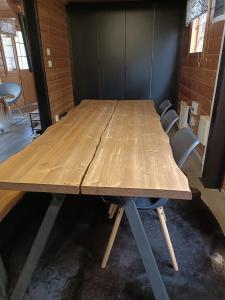 a large wooden table in a room with chairs at Villa Särkkä in Kalajoki +11 photos