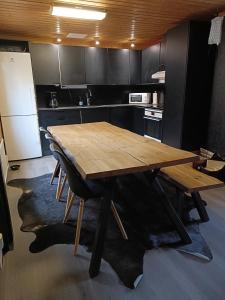 a kitchen with a wooden table in a kitchen at Villa Särkkä in Kalajoki