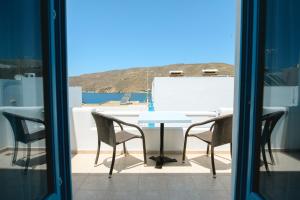 a table and chairs on a balcony with a view at levante studios 2 in Amorgos