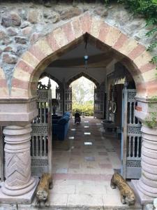 an arched entry way to a house with a stone wall at Dream House by the Aegean Coast in Dikili