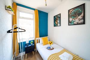 a small room with a bed and a window at Open Mind Property - HotTub, 7 Guests & Parking in Portsmouth