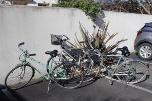 two bikes parked in a parking lot next to a wall at Appartement cosy terrasse parking privé 2 vélos in La Rochelle