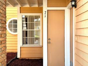 a front door of a house with a window at 2492-3-SW-Spacious Condo in Kissimmee