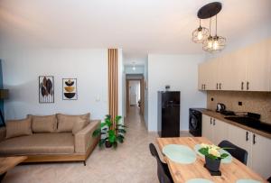 a living room and kitchen with a couch and a table at Angelica's Apartment in Asprovalta