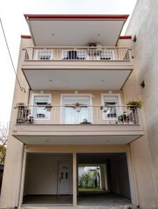 a building with a balcony with plants on it at Angelica's Apartment in Asprovalta