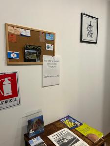 a room with a table with signs on a wall at Pozzuoli B&B exSofer in Pozzuoli
