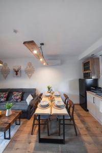 a living room with a table and a couch at MICHAŁÓWKA - Domek w Górach przy Lesie - Energylandia in Targanice +76 photos