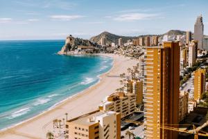 a view of a beach with buildings and the ocean at Sunset Cliffs - Vida de Luxury in Benidorm