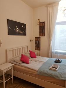 a bedroom with a large bed with red pillows at Cracow Route #2 - Old Town in Kraków +29 photos