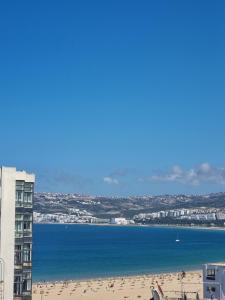 a view of a beach and a building at Luxury Marina Retreat, Walk to the Beach in Tangier
