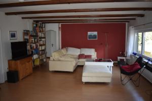 a living room with a couch and a tv at Ferienhaus Bella Vista Edersee in Vöhl