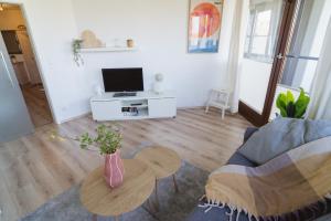 a living room with a couch and a table at Erholung im Trave Kieker 004 mit Pool und Sauna in Lübeck