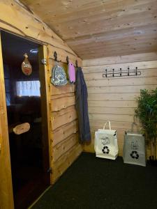 a wooden cabin with two bags and a door at Wilderness cottage 6 people in Kiruna +45 photos