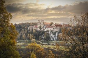 a castle on top of a hill with trees at Cracow Route #2 - Old Town in Kraków