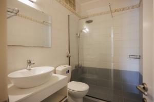 a bathroom with a sink and a toilet and a shower at Blue Coast Suites - Seaside Retreat with Pool in Exclusive Kommeno in Kommeno