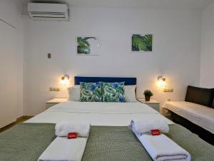 sypialnia z dużym łóżkiem i ręcznikami na nim w obiekcie Estudio BenalBeach NEW w mieście Benalmádena